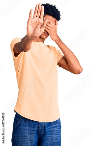 Young african american man wearing casual clothes covering eyes with hands and doing stop gesture with sad and fear expression. embarrassed and negative concept.