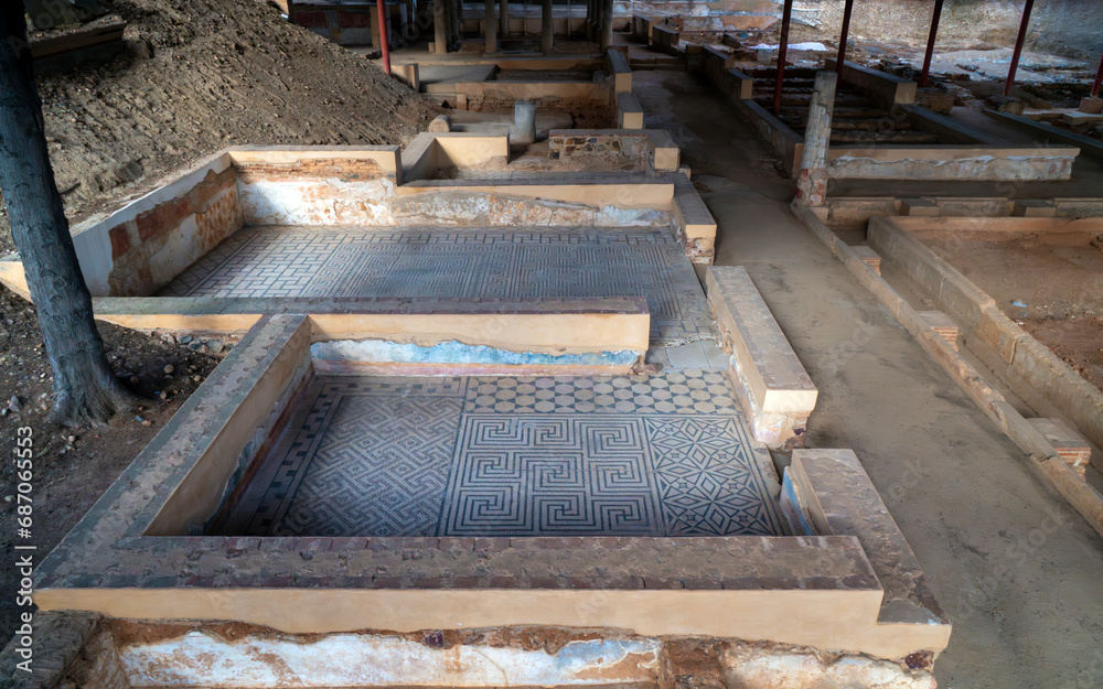 Archaeological remains of the floors of different Roman rooms with the floor decorated with mosaics with blue geometric figures that create a fractal structure in the Mitreo house in Mérida, Spain. Archaeological remains of the floors of different Roman rooms with the floor decorated with mosaics with blue geometric figures that create a fractal structure in the Mitreo house in Mérida, Spain.
