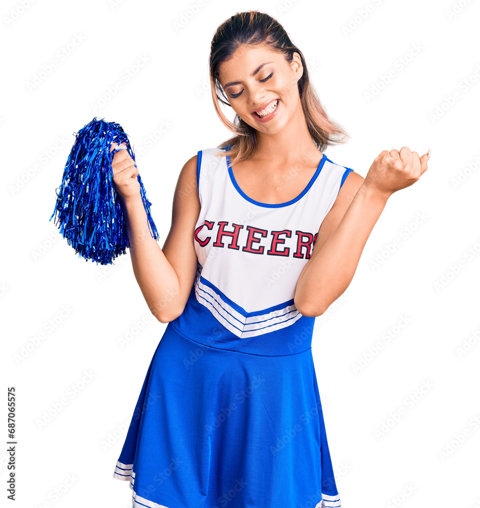 Young beautiful woman wearing cheerleader uniform very happy and excited doing winner gesture with arms raised, smiling and screaming for success. celebration concept. Young beautiful woman wearing cheerleader uniform very happy and excited doing winner gesture with arms raised, smiling and screaming for success. celebration concept.
