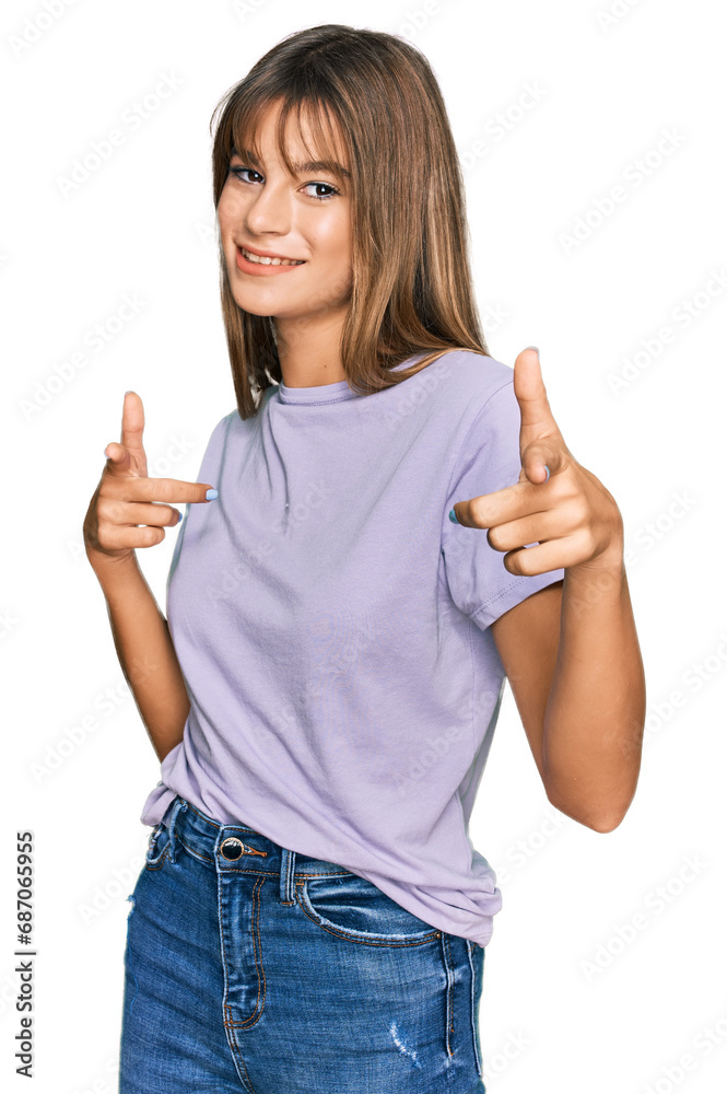 Teenager caucasian girl wearing casual clothes pointing fingers to camera with happy and funny face. good energy and vibes. Teenager caucasian girl wearing casual clothes pointing fingers to camera with happy and funny face. good energy and vibes.