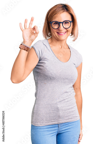 Young blonde woman wearing casual clothes smiling positive doing ok sign with hand and fingers. successful expression.