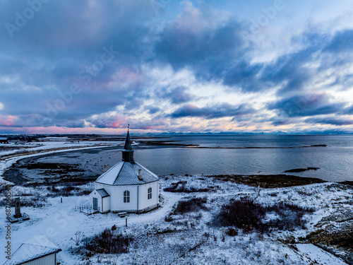 aerial view over Dverberg Church in norway during sunrise in winter photo