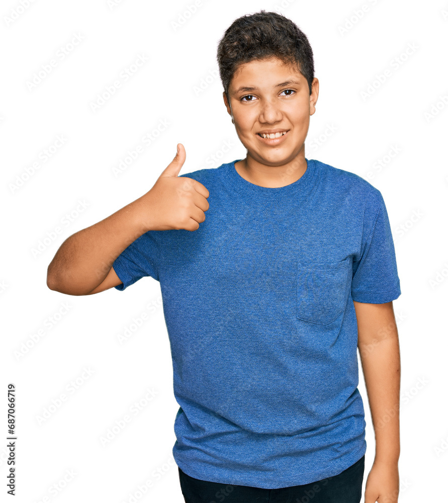 Teenager hispanic boy wearing casual clothes doing happy thumbs up gesture with hand. approving expression looking at the camera showing success. Teenager hispanic boy wearing casual clothes doing happy thumbs up gesture with hand. approving expression looking at the camera showing success.