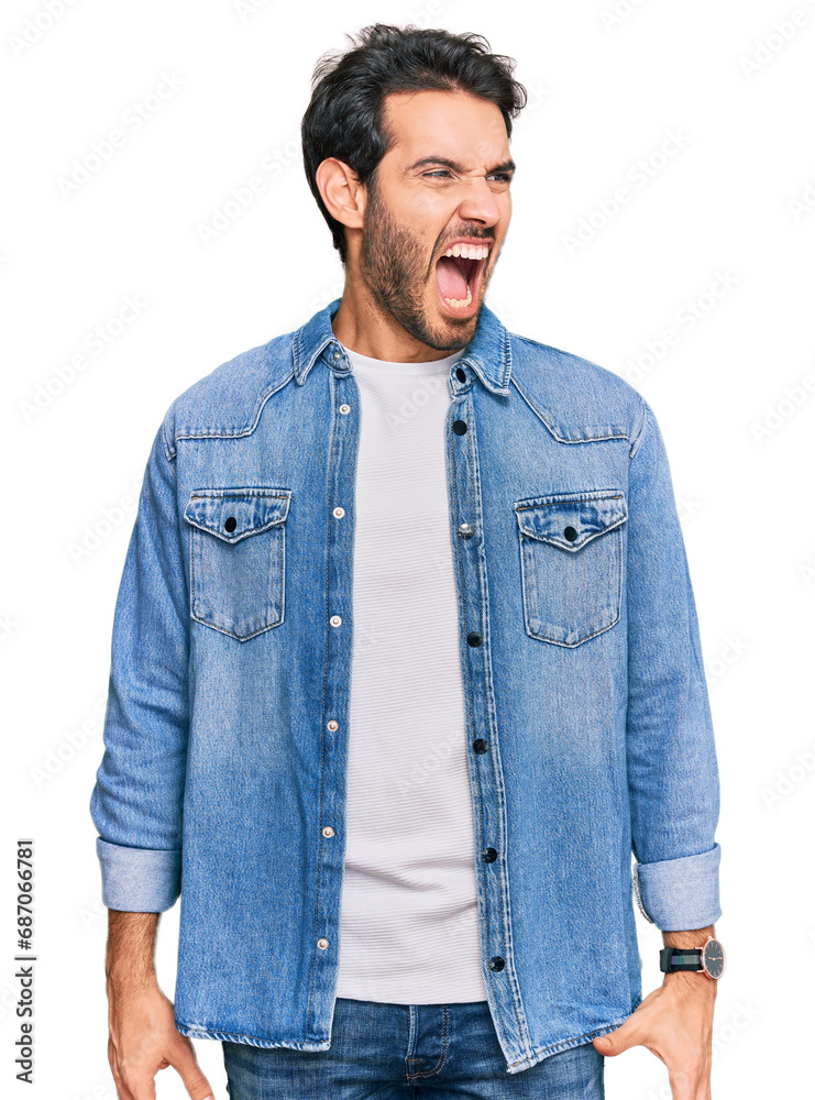 Young hispanic man wearing casual clothes angry and mad screaming frustrated and furious, shouting with anger. rage and aggressive concept. Young hispanic man wearing casual clothes angry and mad screaming frustrated and furious, shouting with anger. rage and aggressive concept.