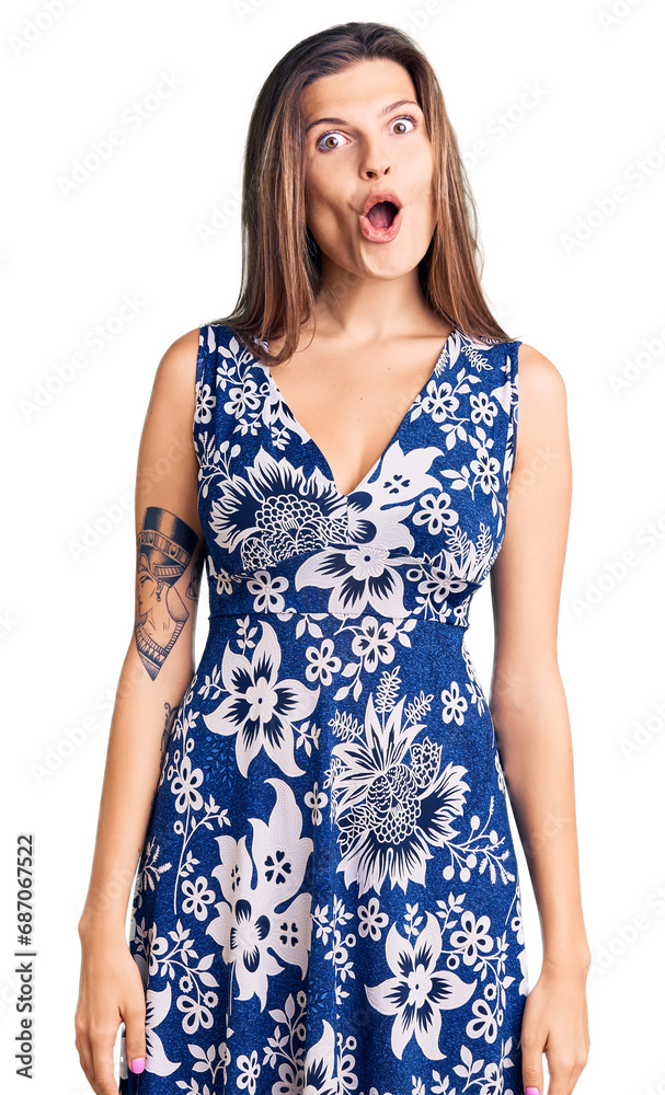Beautiful caucasian woman wearing summer dress afraid and shocked with surprise expression, fear and excited face. Beautiful caucasian woman wearing summer dress afraid and shocked with surprise expression, fear and excited face.
