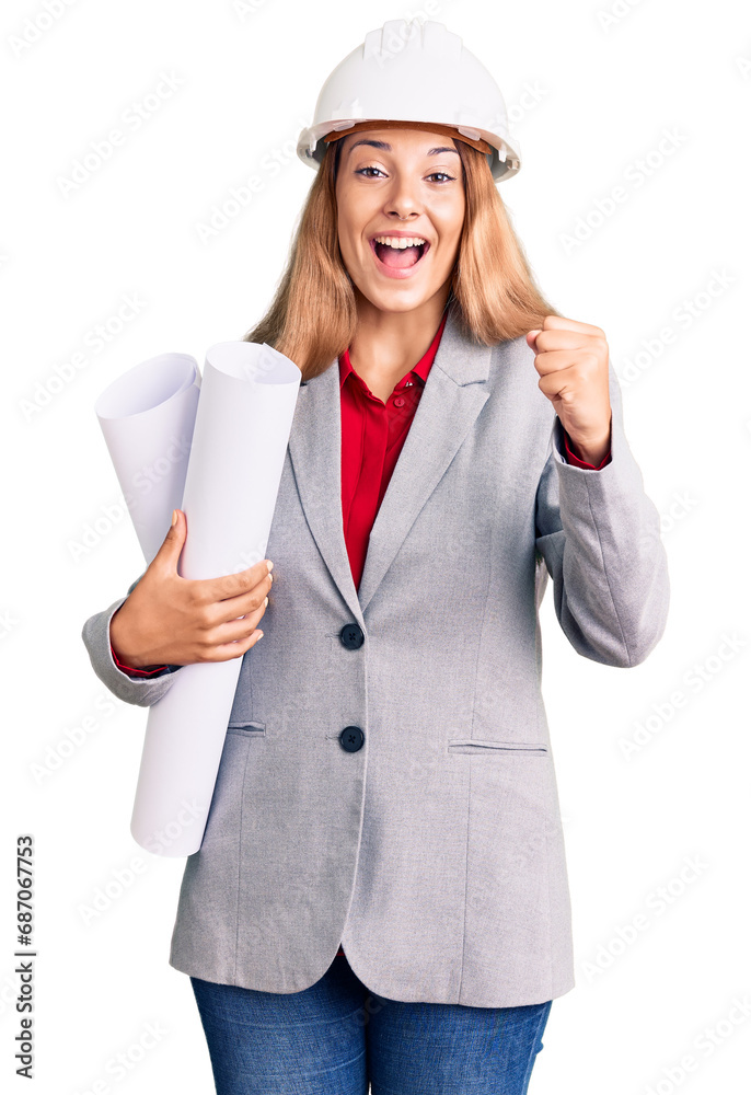 Beautiful young woman wearing architect hardhat holding build project screaming proud, celebrating victory and success very excited with raised arms Beautiful young woman wearing architect hardhat holding build project screaming proud, celebrating victory and success very excited with raised arms
