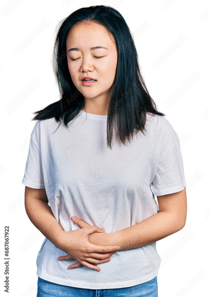 Young chinese woman wearing casual white t shirt with hand on stomach because nausea, painful disease feeling unwell. ache concept. Young chinese woman wearing casual white t shirt with hand on stomach because nausea, painful disease feeling unwell. ache concept.