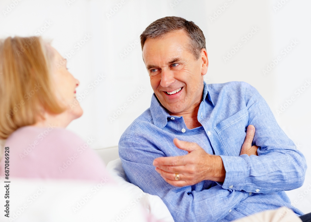 Obraz premium Home, relax and senior couple with love, conversation and communication with weekend break, cheerful and joy. Retirement, old man and mature woman with discussion, bonding together or talk with chat