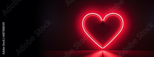 Valentines Day card  heart shaped red neon light over black.. Area for text on the left. © berkeley