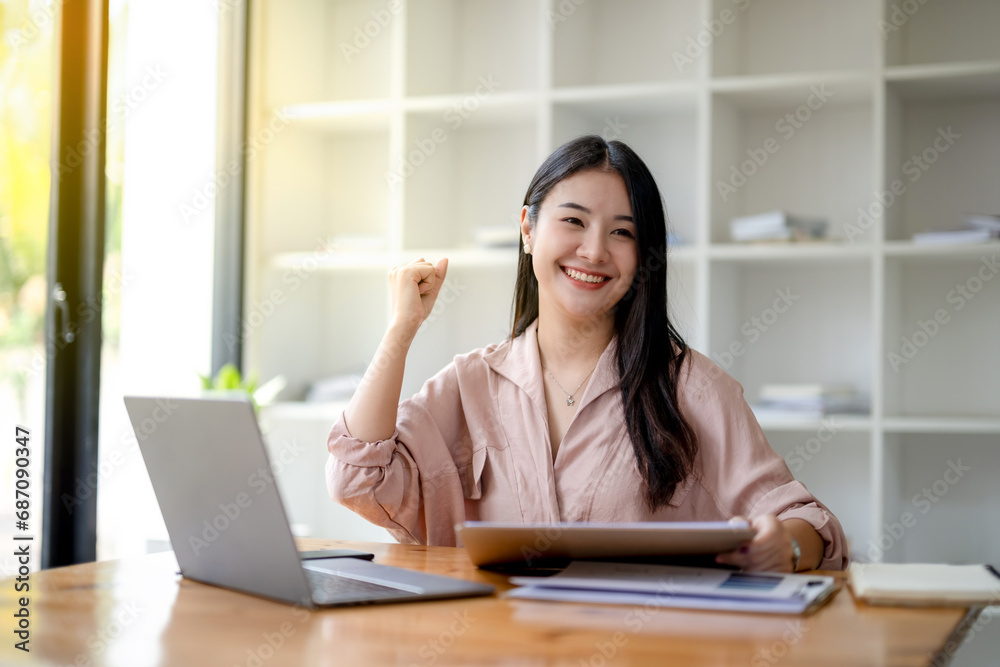 Asian businesswoman congratulates on project success. Satisfied with the good results of the report received.