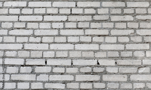 Old grey brick wall background. Rough brick wall texture. Abstract grey brick wall surface. Close up.
