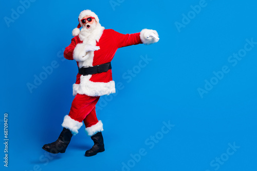 Full length photo of mature pensioner man energetic dancing wear trendy santa claus costume coat isolated on blue color background
