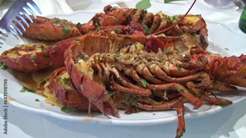 People eating paccheri with lobster’s sauce at a Neapolitan restaurant. People eating paccheri with lobster’s sauce at a Neapolitan restaurant.