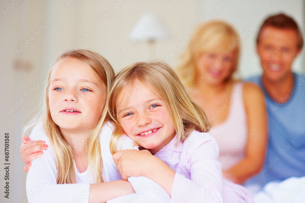 Portrait, siblings or sisters for hug together on bed, relax wellness and happiness with care support in home. Girls, embrace and smile face for bonding with proud parents and morning love in house Portrait, siblings or sisters for hug together on bed, relax wellness and happiness with care support in home. Girls, embrace and smile face for bonding with proud parents and morning love in house
