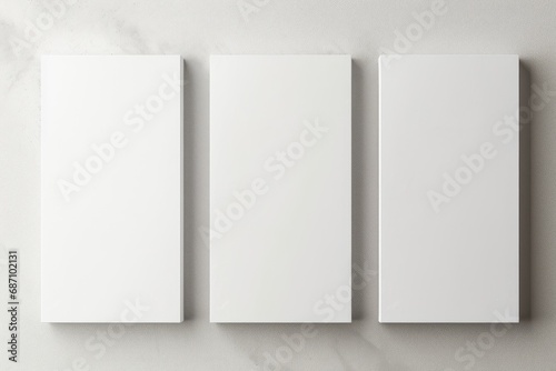 Three empty white vertical rectangle poster mockups. Flat lay, top view. Three Blank White Rectangle Picture Frames on a Wall