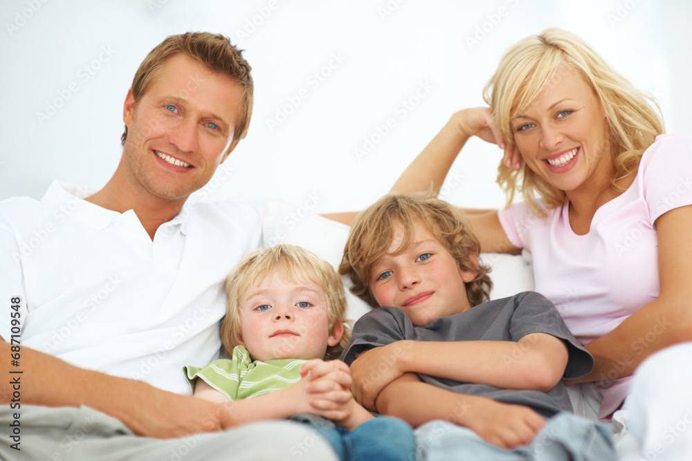 Portrait, smile and family in home together, bonding and relax, care or support on living room sofa. Happy face, parents and children in house lounge on couch with love for kids, father and mother