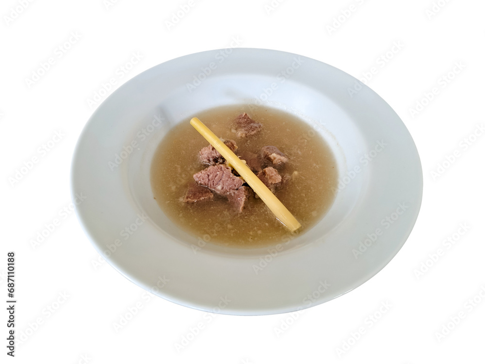 Indonesian beef soup or soto daging in a serving bowl, flat lay on white plate, isolated on white background Indonesian beef soup or soto daging in a serving bowl, flat lay on white plate, isolated on white background