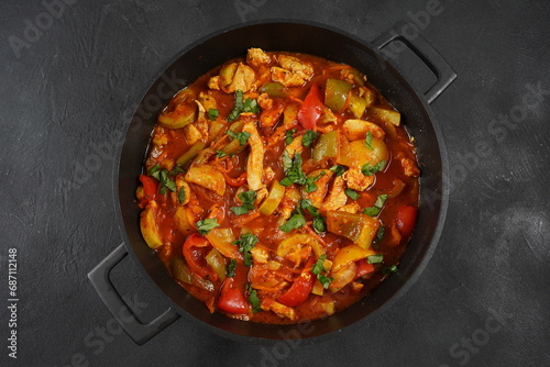 Chicken breast stew with vegetables and herbs and tomato sauce. photo