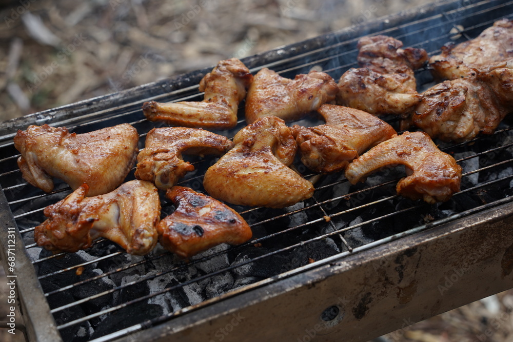 Fresh chicken wings grill meat on fire. Making barbecue on the grill