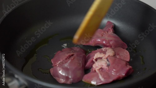 Cooking chicken liver in a pan on the stove. Preparation of offal
