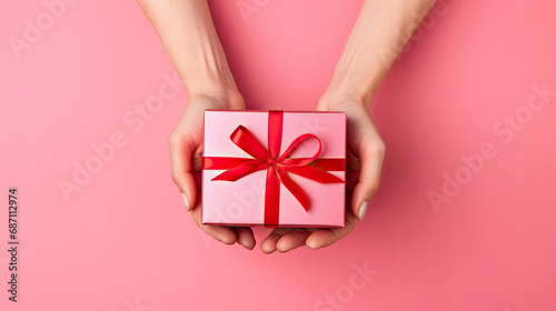 person holding a gift box, woman's hand holding red gift  box, Present for birthday, valentine day, Christmas, New Year. Congratulations background copy space.