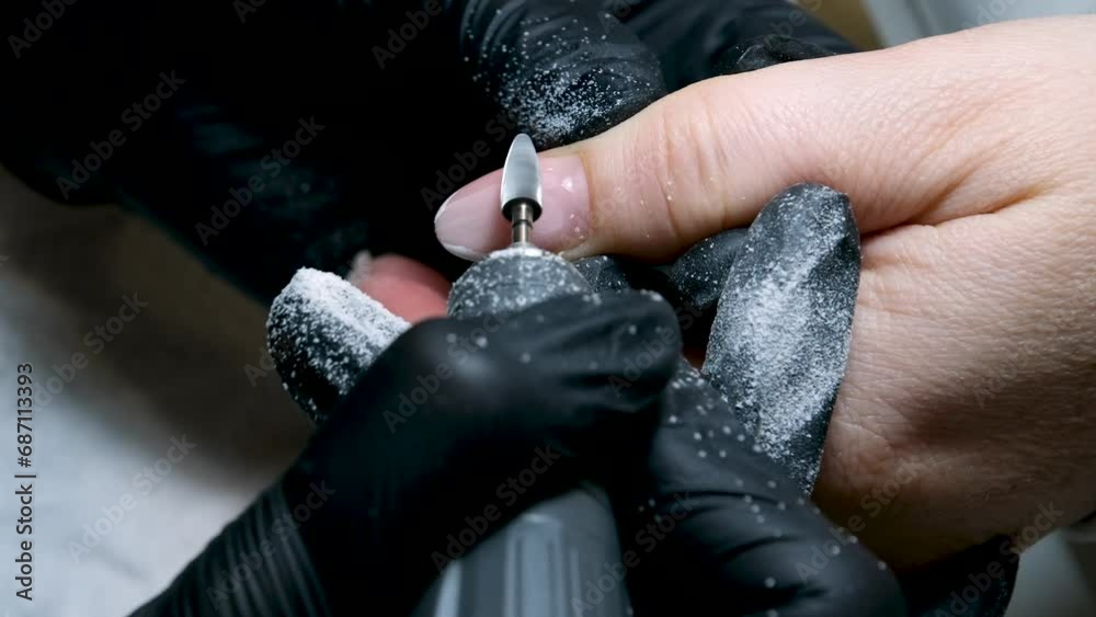 Manicurist does the processing of the cuticle to a special apparatus cleaning nails using manicure cutter. macro. close-up removing gel, manicure machine, Female master. Nail technician cleans nails