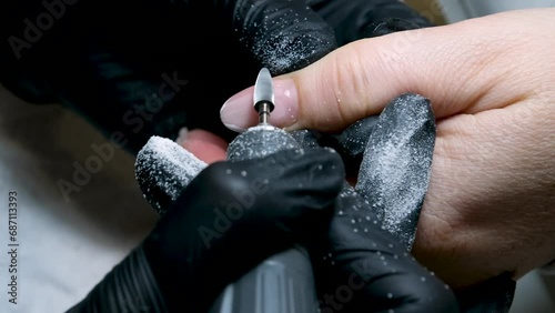 Manicurist does the processing of the cuticle to a special apparatus cleaning nails using manicure cutter. macro. close-up removing gel, manicure machine, Female master. Nail technician cleans nails