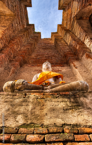 A sandstone sculpture of Buddha at Prasat Nakhon Luang in Ayutthaya, Thailand.