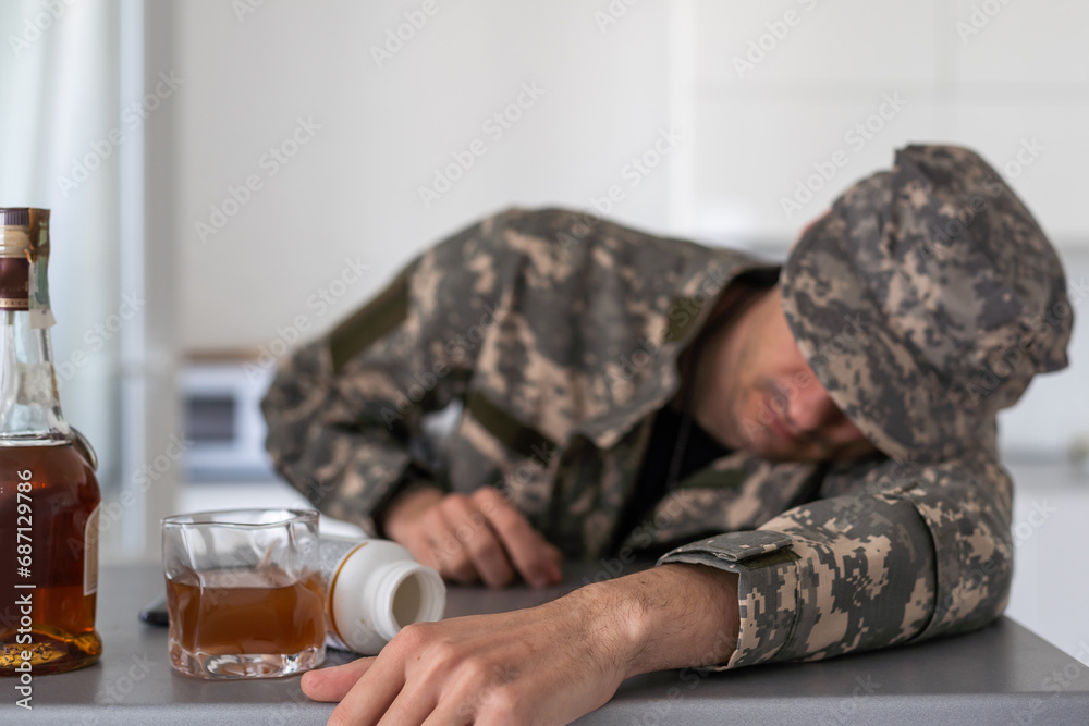 A man in camouflage suffers from depression after returning from the army. He drinks alcohol in the basement. He is tormented by heavy memories.
