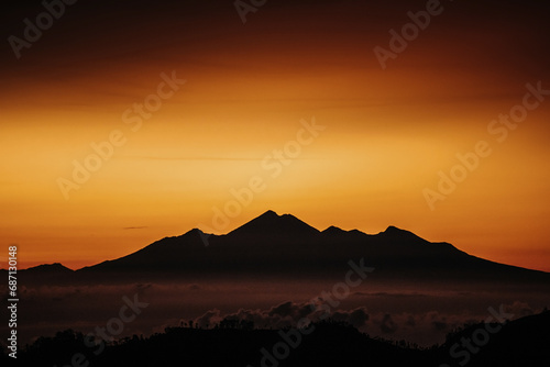 View of mountain with fog at sunset