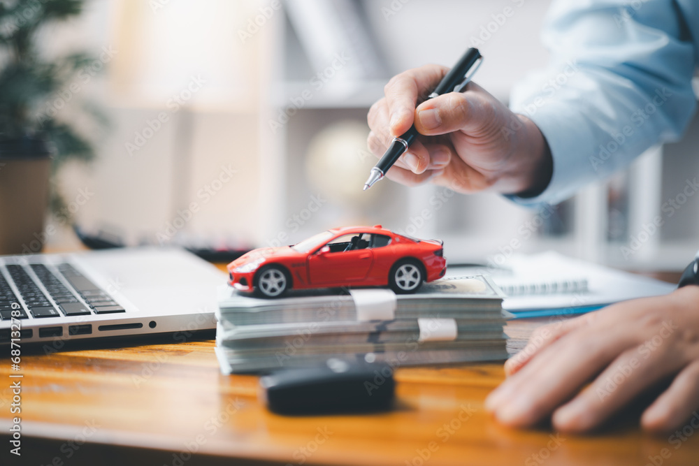 Toy Car In Front Of Businessman Calculating Loan. Saving money for car concept, trade car for cash concept, finance concept. - obrazy, fototapety, plakaty 