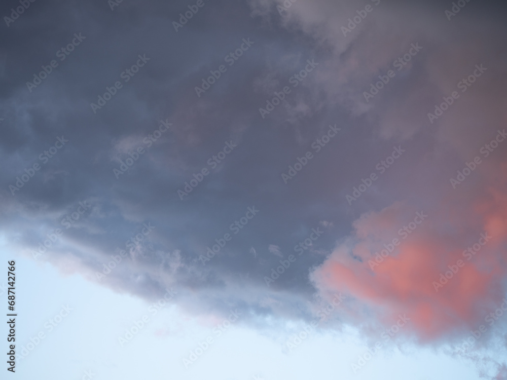 Blue sky after rain,. Beautiful Cumulus clouds flying across the sky, sunset rays, pink and orange shades in the clouds, deep blue sky Blue sky after rain,. Beautiful Cumulus clouds flying across the sky, sunset rays, pink and orange shades in the clouds, deep blue sky