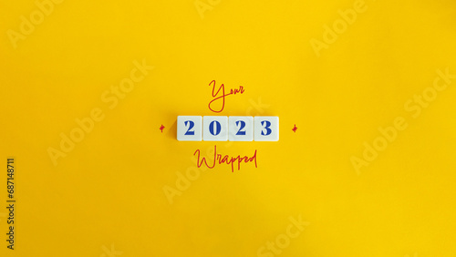 Year 2023 Recapitulation, Wrapping, Summarising. Concept Image. Cursive Text and Block Letter Tiles on Yellow Background.