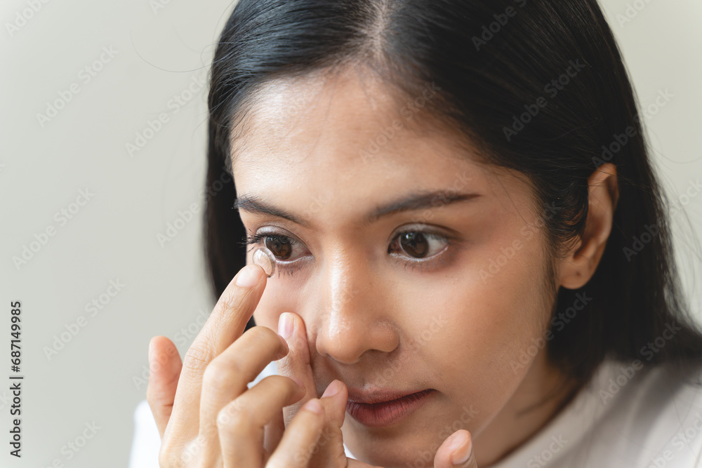 Optimise vision by contact lens, Close-up of woman face during insert contact lens to her eyes. Optimise vision by contact lens, Close-up of woman face during insert contact lens to her eyes.