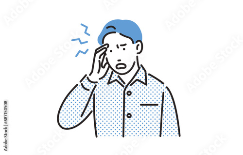 風邪をひいて頭が痛い男性