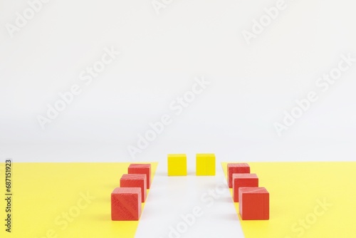 Simmetrico con cubi di legno, sfondo giallo. photo