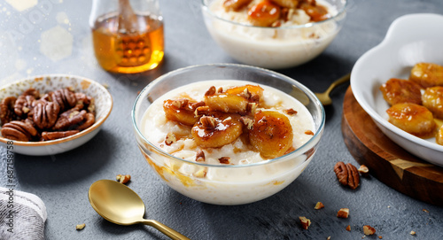Fresh prepared rice pudding served with caramelized banana, honey and pecan nuts.