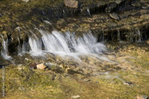 Waterfall over natural rocks