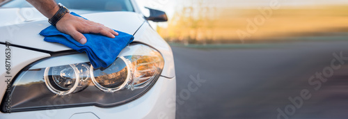 man cleaning car with cloth photo