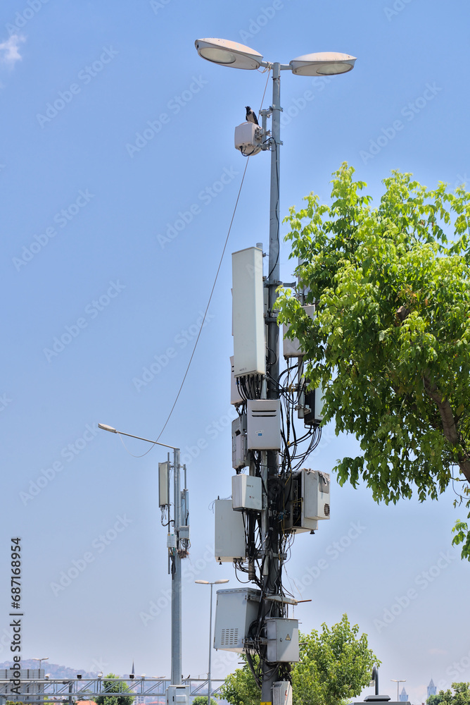 Internet communications and connections. boxes with a bunch of wires are hung on a pole Internet communications and connections. boxes with a bunch of wires are hung on a pole
