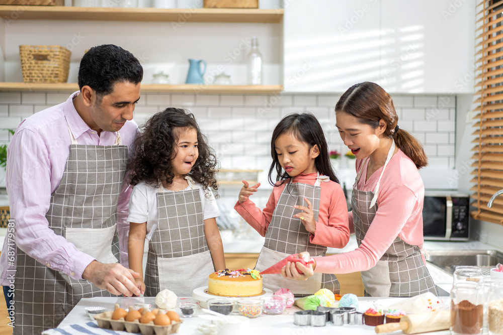 Portrait of enjoy happy love asian family father and mother with little asian girl daughter child play and having fun cooking food together with baking cookie and cake ingredient in kitchen