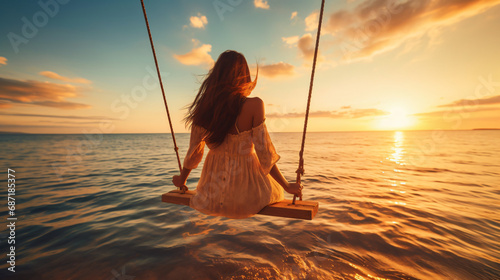 Happy young woman on wooden swing in water