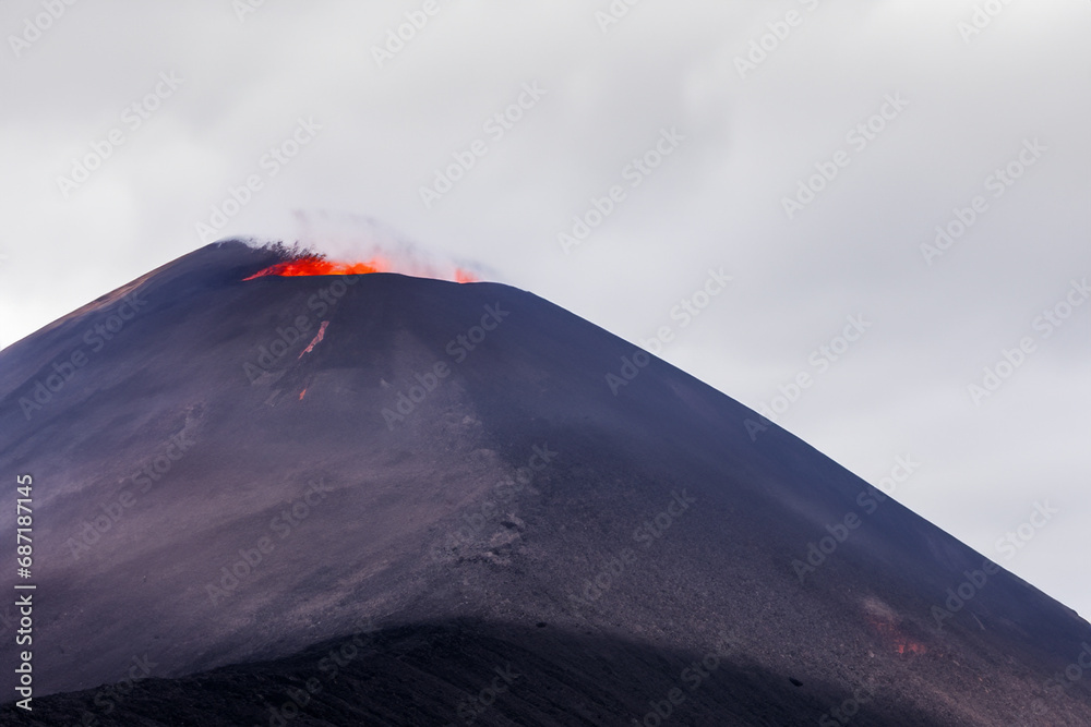 Etna. They overturn with magma on the walls of the volcanic cone. Hot wash. New eruption. 2023. Hot rocks.