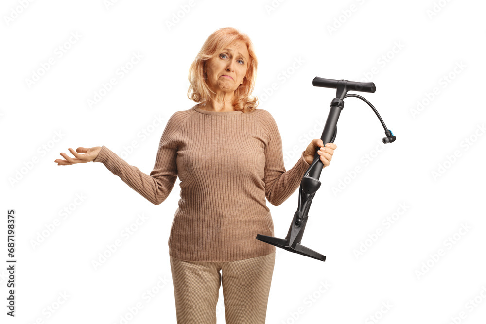 Confused woman holding a manual tire pump Confused woman holding a manual tire pump