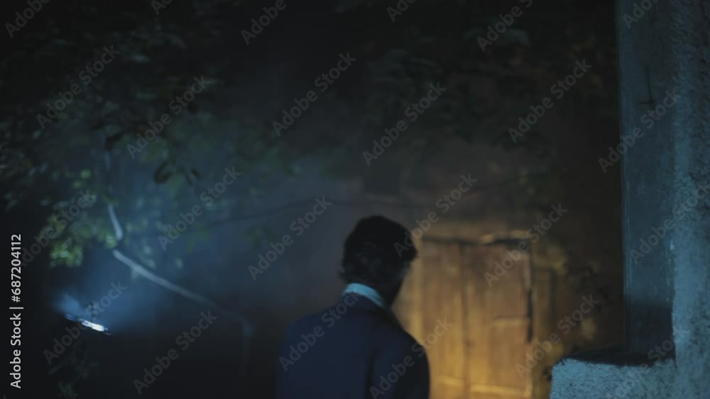 Cinema-style shot of a gangster walking downstairs in a garage-like area, creative HD stock footage. Cinema-style shot of a gangster walking downstairs in a garage-like area, creative HD stock footage.