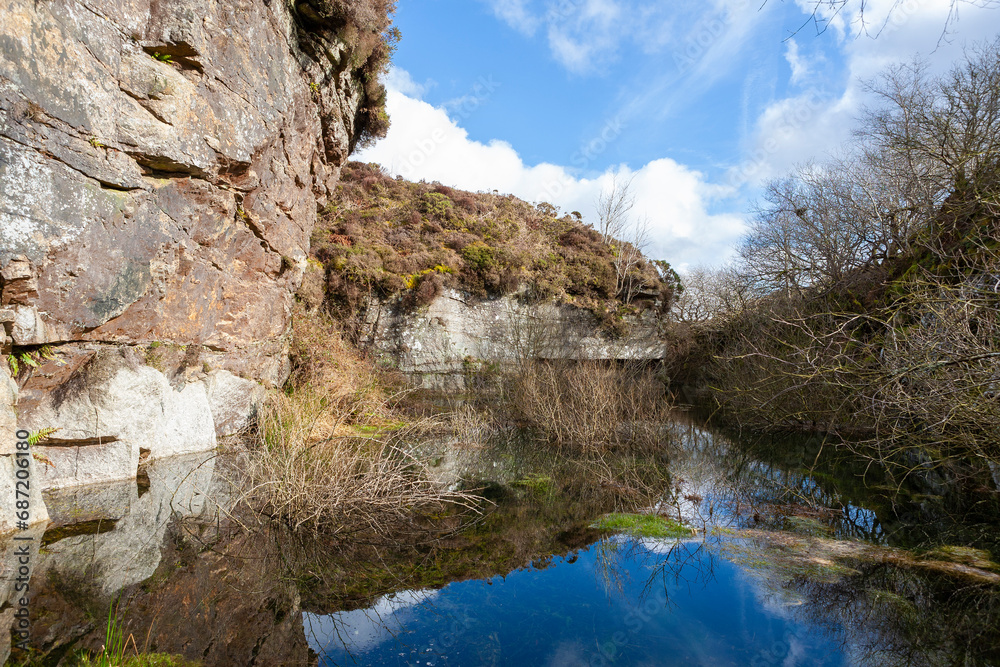 The flooded remains of the long-abandoned 19th century Haytor Quarry, in production between 1820 and 1850: Haytor Down, Dartmoor,  Devon, UK