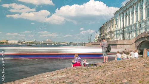 People on Hermitage Bridge and Neva River Stairs Timelapse with Tourist Boat on Winter Canal Background. St. Petersburg, Russia photo