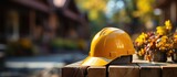 yellow safety helmet or hardhat, construction worker , is placed on wooden