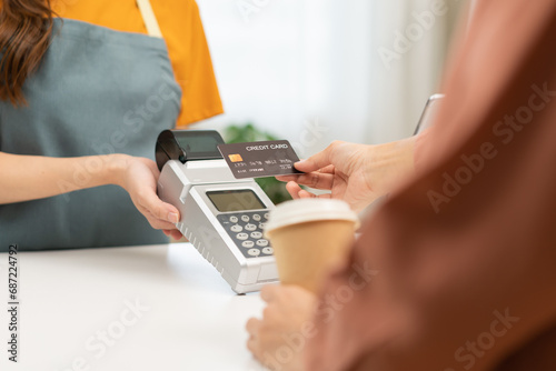 Pay, cashless technology concept, hand of customer using credit card for terminal payment, paying money to transfer cashless at cafe grocery retail shop to buy breakfast, holding wireless bank machine
