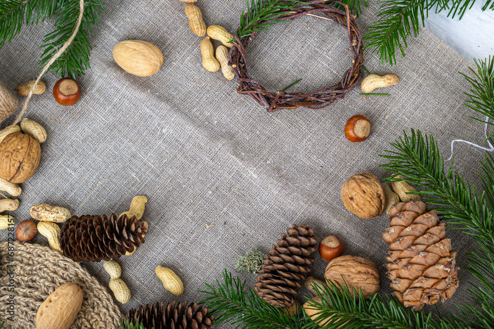 Natural background with natural eco-friendly materials, nuts, pine cones, pine branches and jute thread